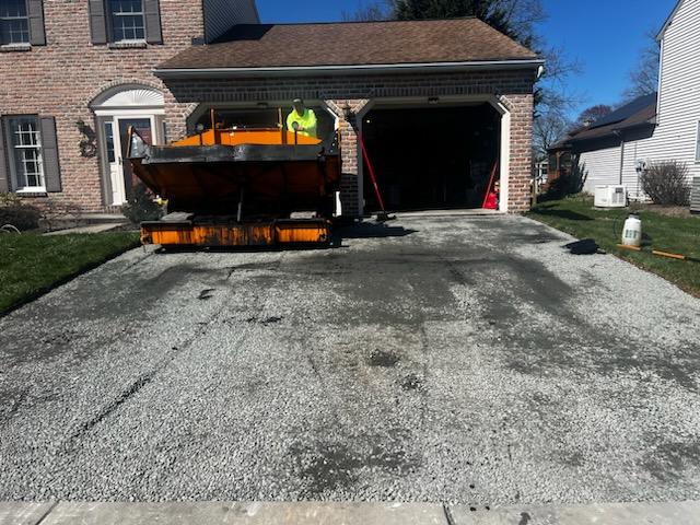 Old driveway removed and a new stone base installed before repaving, by R. Stanley's Paving.